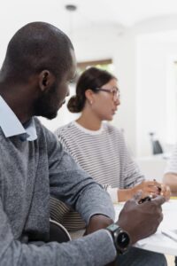 Man contemplating to start a difficult conversation with female colleague